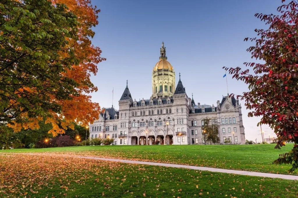 Connecticut State Capitol framed by autumn trees in Hartford